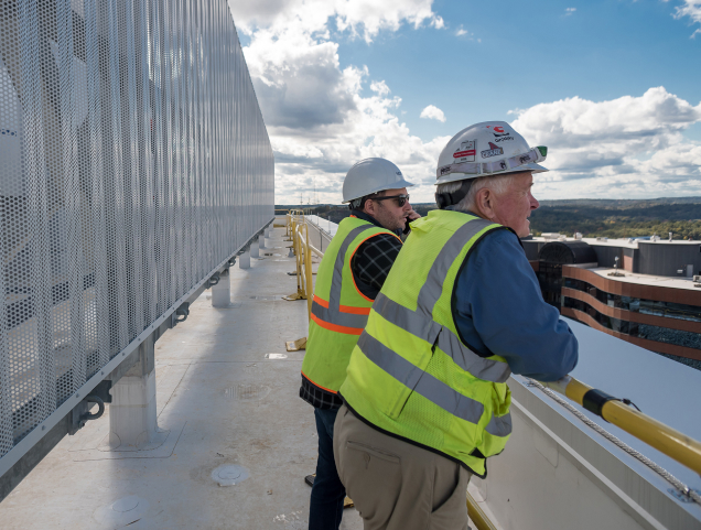 Workers standing on a roof looking out